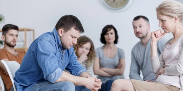 Man making confession during support group meeting